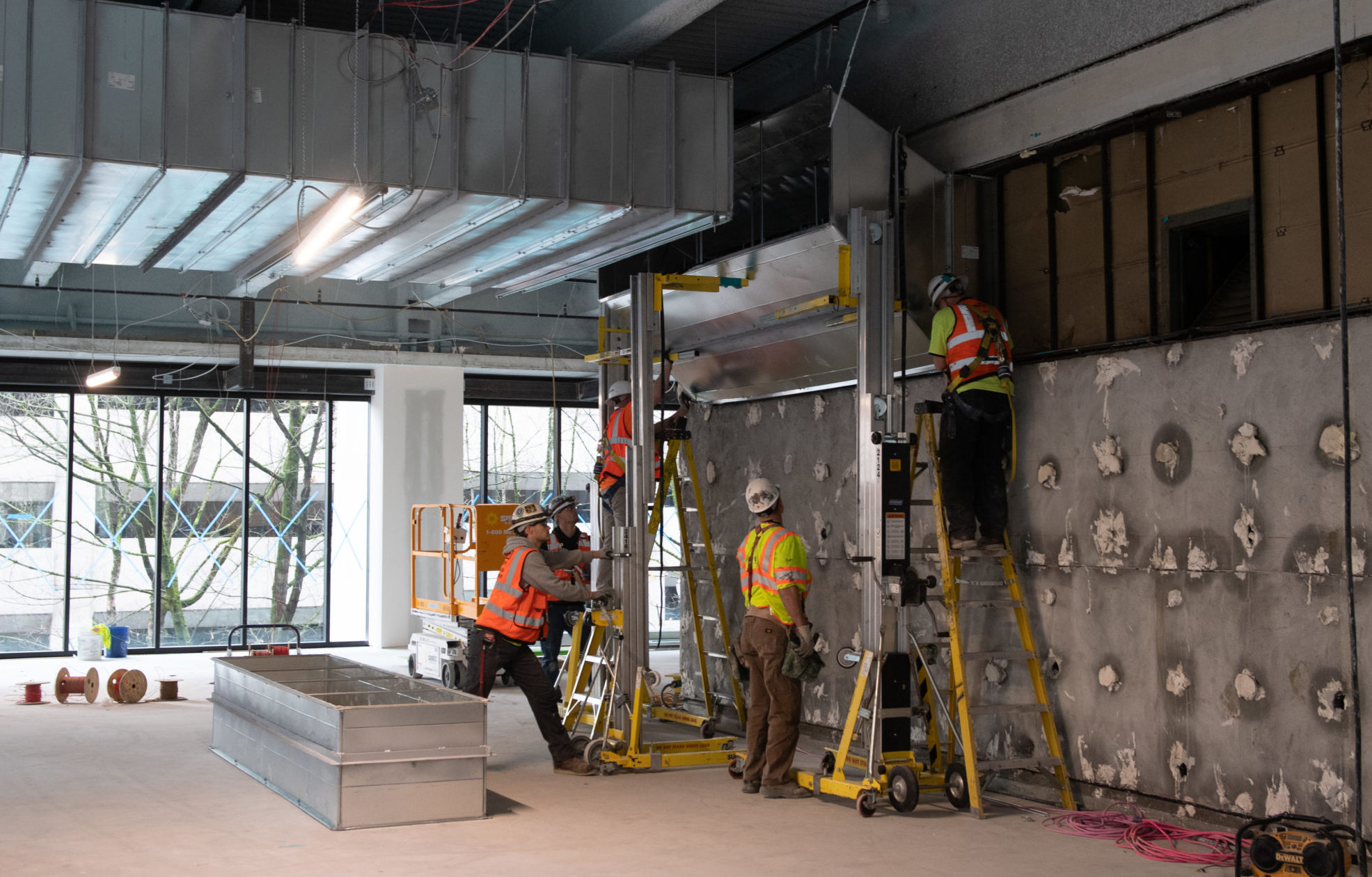 Streimer team members install large rectangular duct